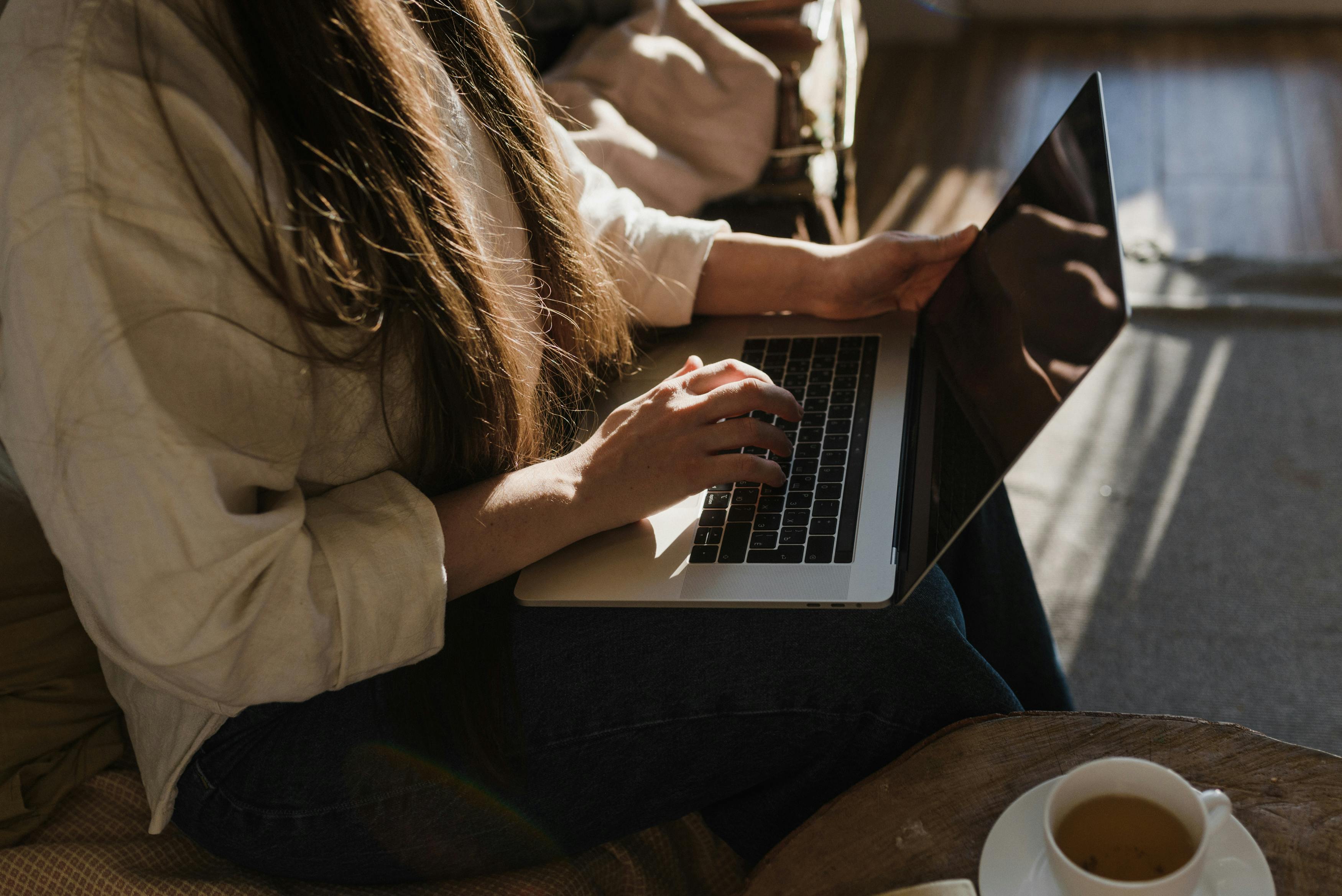 Close Up Photo of a Person Using a Laptop